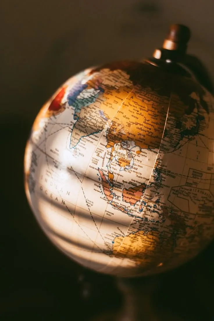A desk globe in warm evening light, turned towards Asia and the Indian Ocean